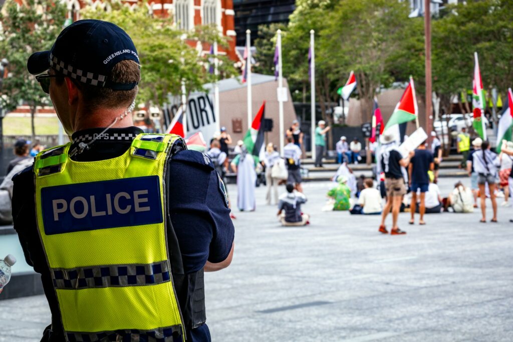A police officer standing in front of a crowd of people