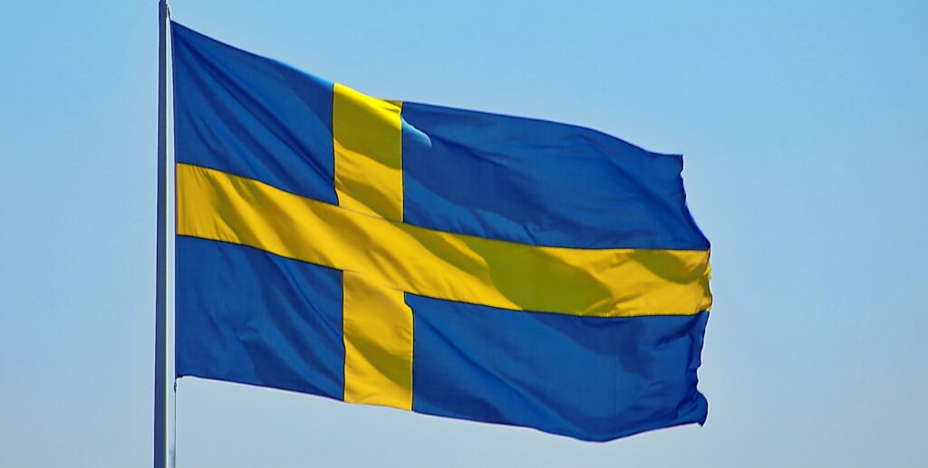 a blue and yellow flag flying in the sky