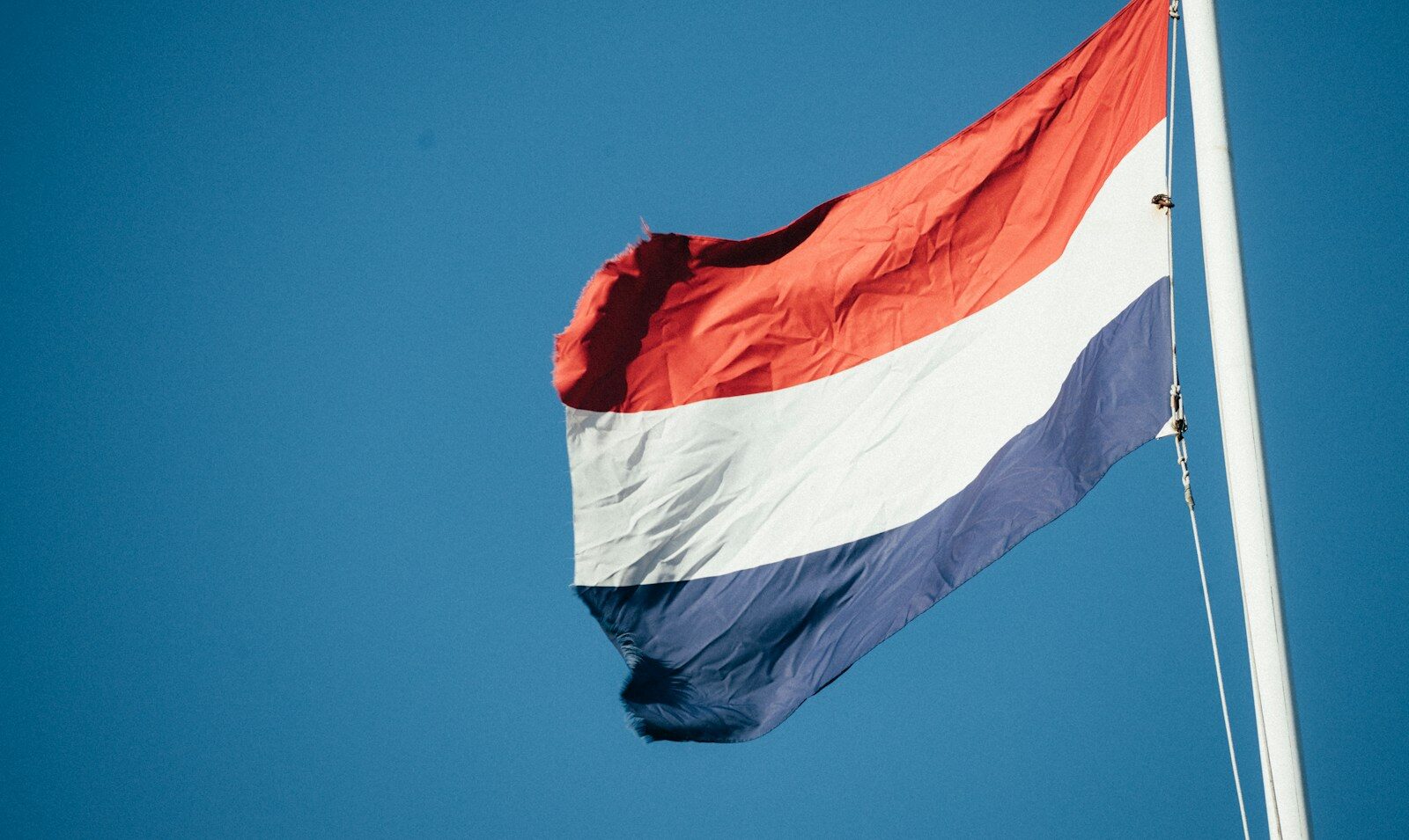 A red white and blue flag flying in the wind