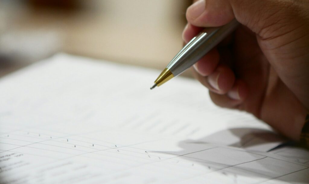 a hand holding a pen