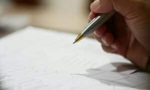 a hand holding a pen