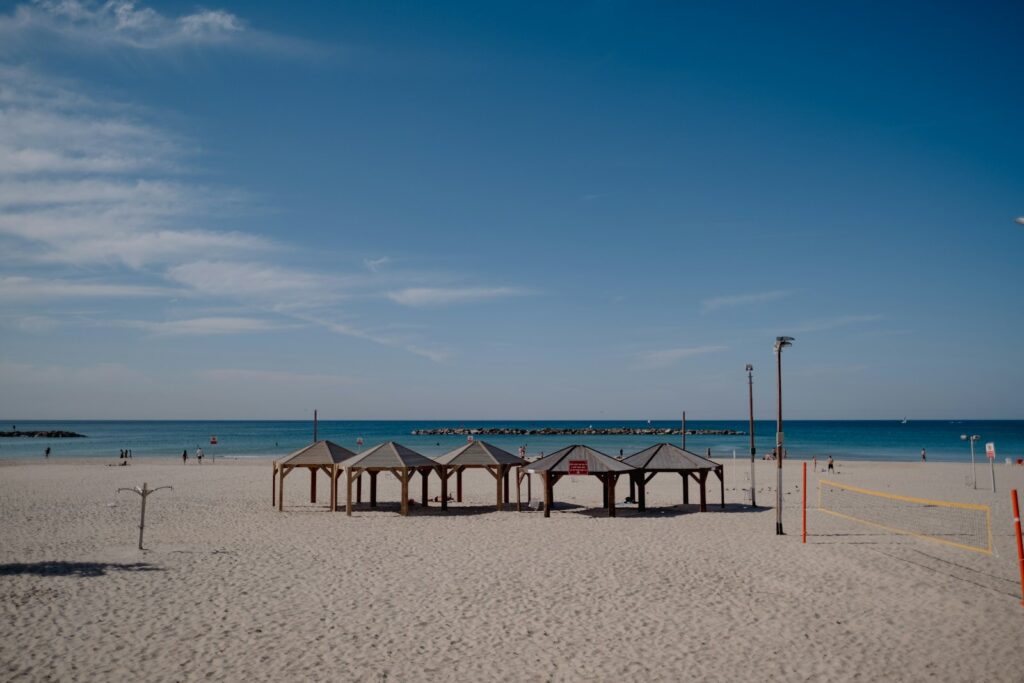 a sandy beach with a volleyball court and volleyball goal