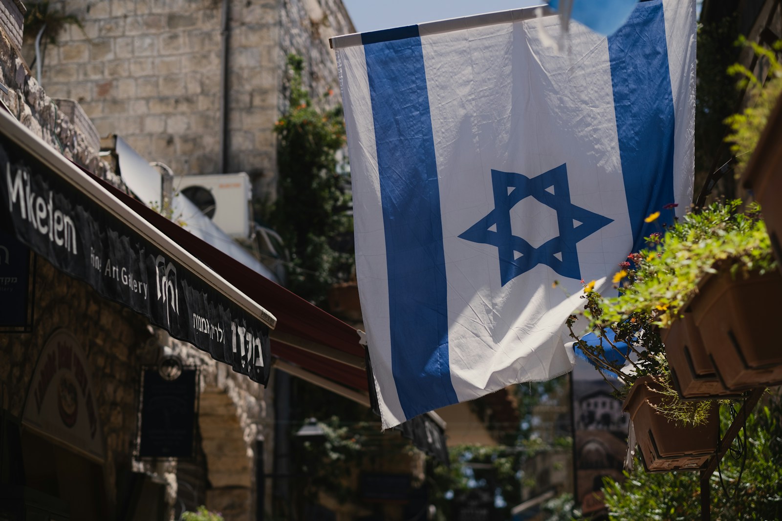 a flag hanging from a building in a city