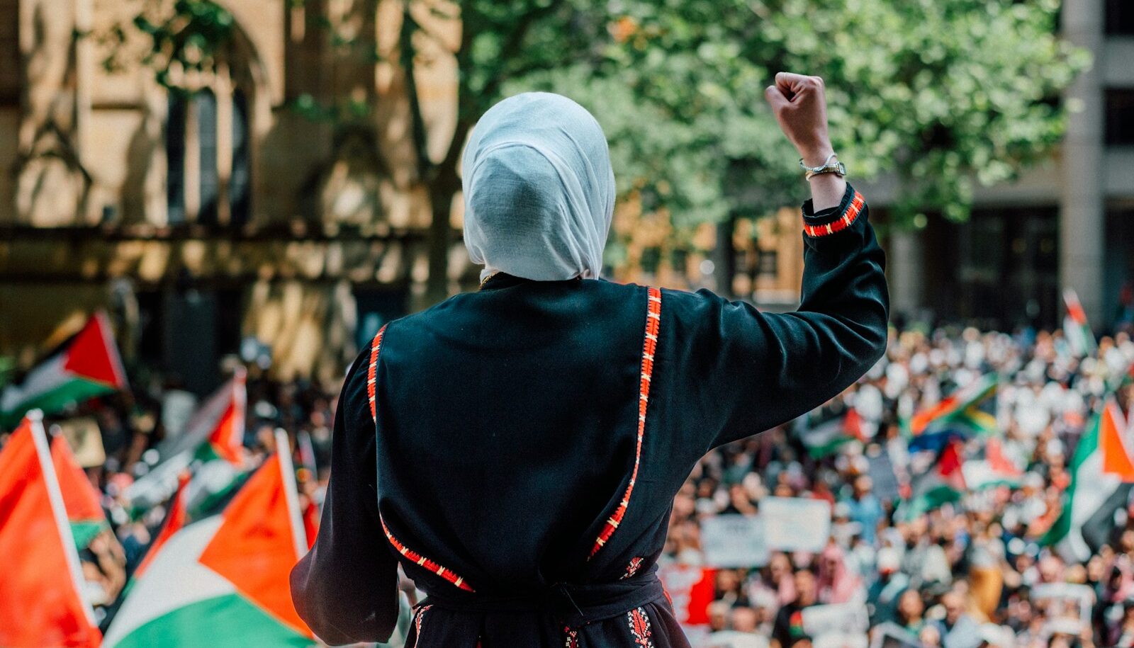 a woman in a black robe and a crowd of people
