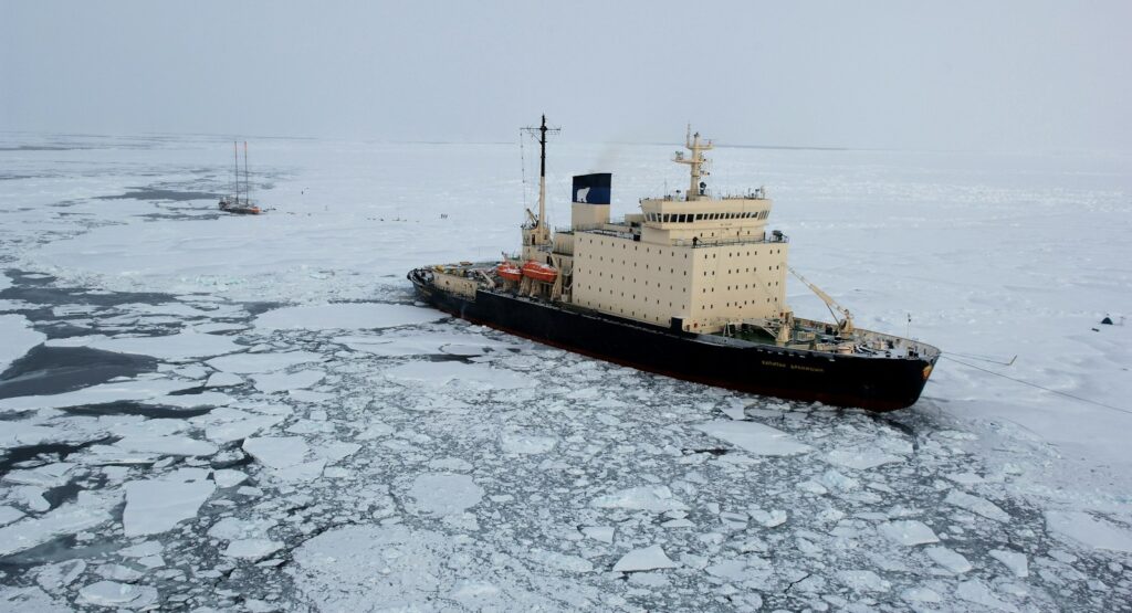 cargo ship on iced body of water