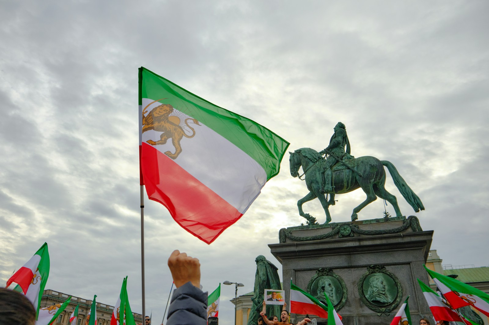 a statue of a person riding a horse with a flag