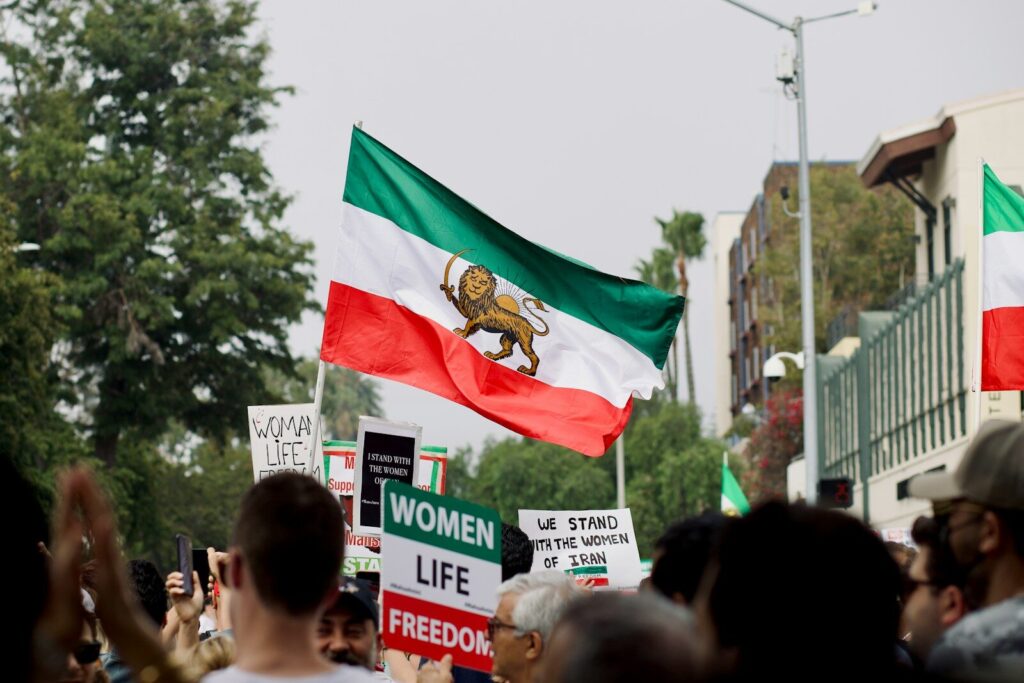 a group of people holding signs and flags